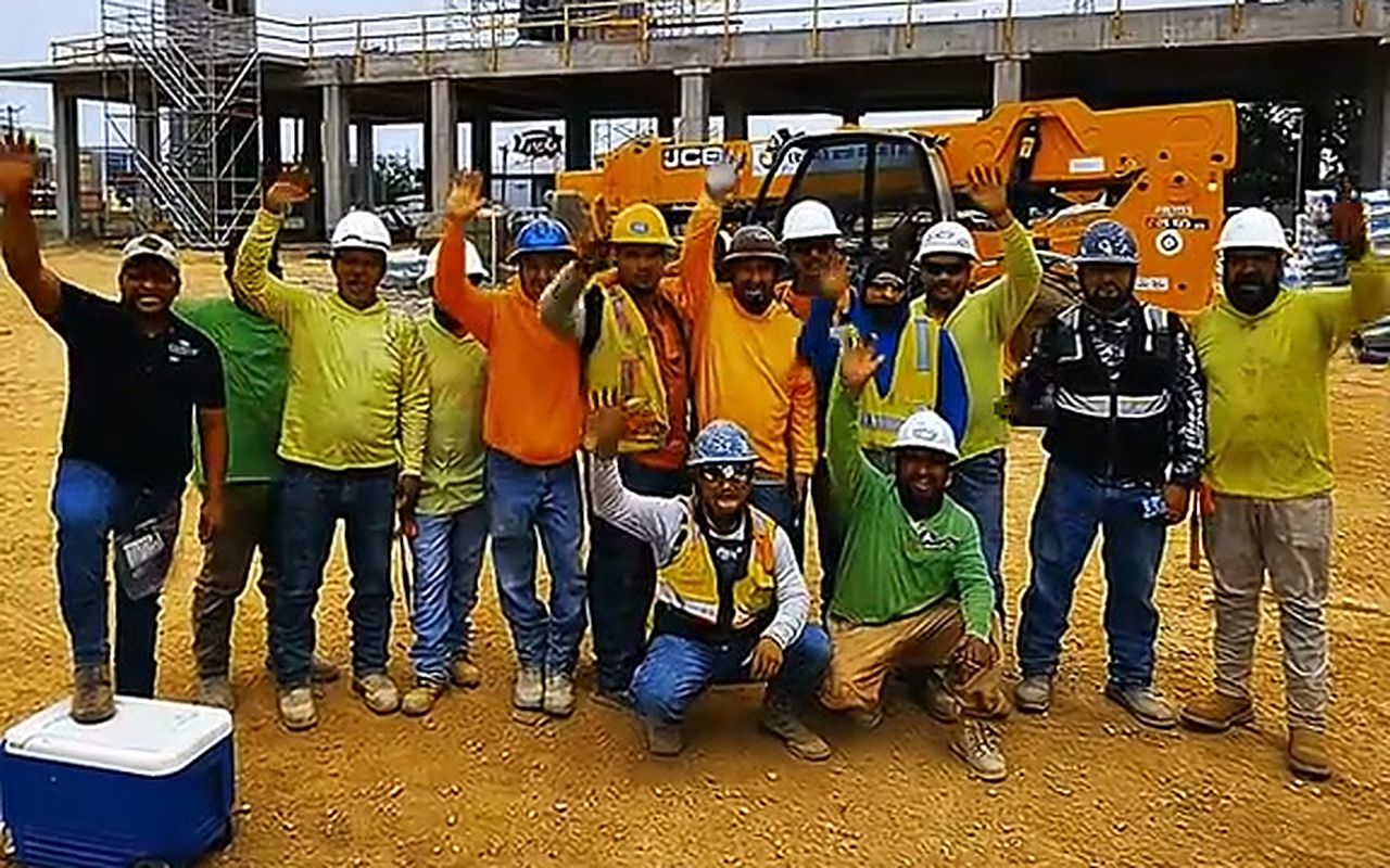 Texas Pro Stucco & Masonry crew in front of the scaffold on the Caravan hotel project